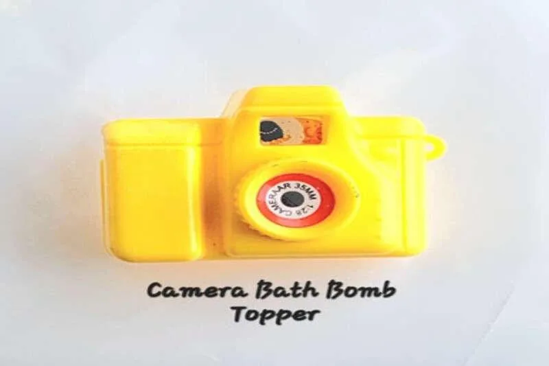 Plastic yellow mini camera bath bomb topper