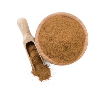 Comfrey Root Powder In Bowl Top View. A small wooden bowl containing comfrey root powder on a white background.