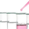 clear liquid in vial with pink liquid in dropper