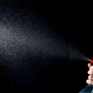 Person spraying room freshener