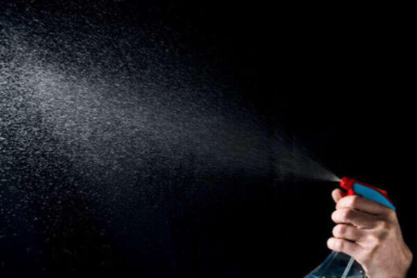 Person spraying room freshener