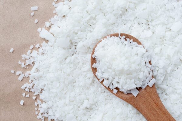 Phytomulse Almond Emulsifier flakes in wooden spoon