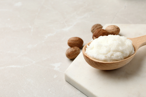 Refined white RBD Shea Butter in wood spoon