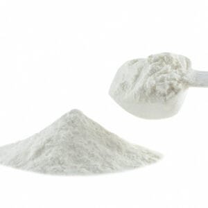 White powder in scoop, with a pile of white powder on white background