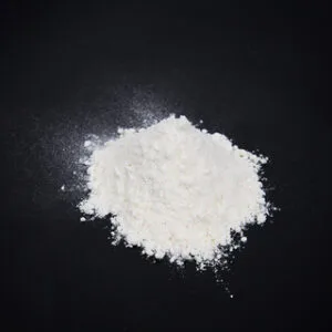 White sodium cocoyl lsethionate (sci) powder on black background