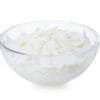 Glyceryl Stearate & Peg 100 Stearate white flakes in clear bowl on white background